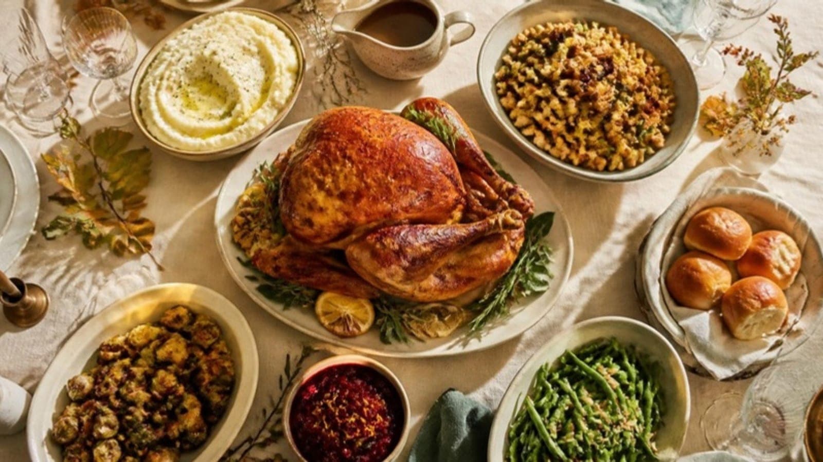 Thanksgiving dinner spread with turkey, stuffing, potatoes and cranberry sauce